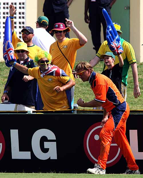 Australian cricket fans show their delight at Tim de Leede's failure to stop the ball at the boundary