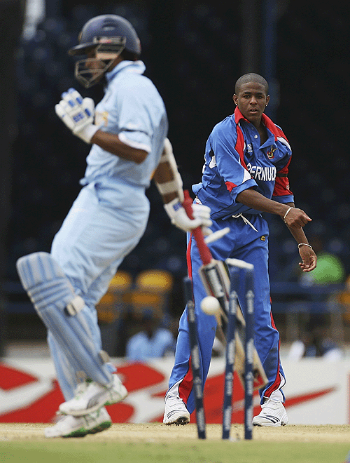 Sourav Ganguly tries to get out of the way as Malachi Jones throws the ball at the stumps