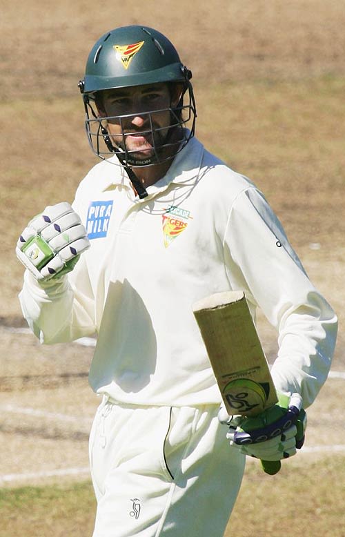 Sean Clingeleffer pumps his fist after reaching his half-century