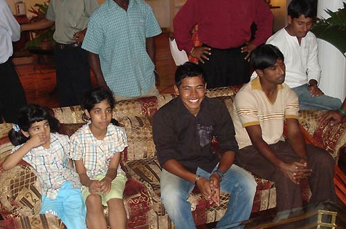 Mushfiqur Rahim poses with two Bangladeshi kids in the lobby of the Pegasus Le Meridien