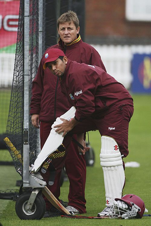 Ramnaresh Sarwan straps on his pads ahead of a net session at Lord's, watched by David Moore