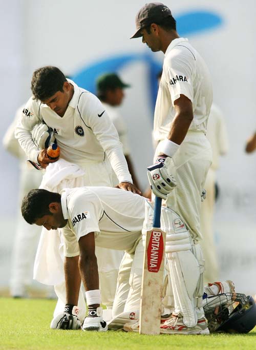 Wasim Jaffer vomits as teammate Rajesh Pawar attends to him and captain Rahul Dravid looks on