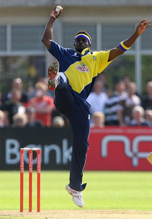 Carl Greenidge stops a return off his bowling