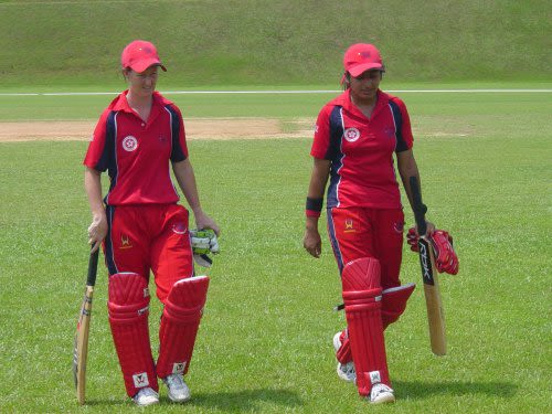 Neisha Pratt and Keenu Gill return to the pavilion after leading Hong Kong to a six-wicket win over Thailand