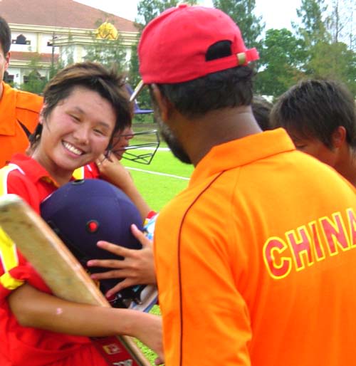 China's coach Rashid Khan congratulates Hu Ting Ting for her match-winning effort