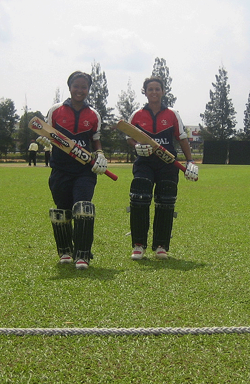 Nary Thapa (left) and Neera Rajopadhyay walk out of the ground after winning the game for Nepal against Hong Kong