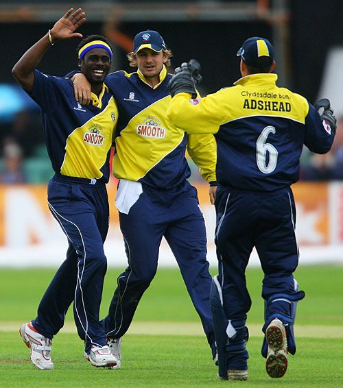 Carl Greenidge is congratulated after dismissing Phil Jaques