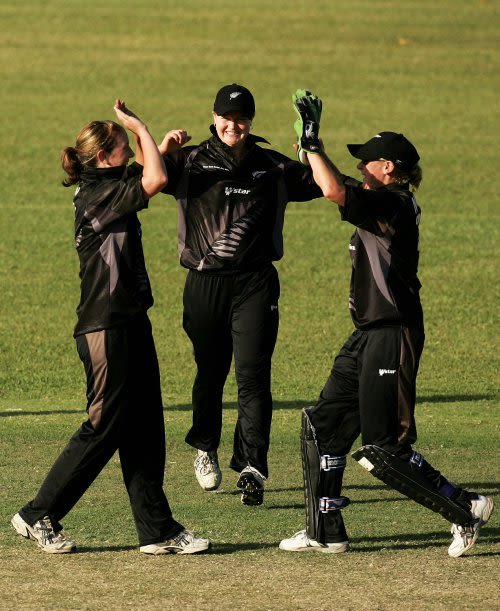Sarah Burke is congratulated by wicketkeeper Rowan Milburn after dismissing Ellyse Perry