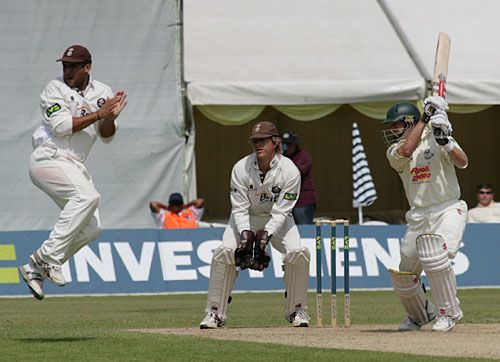 Mark Butcher takes evasive action as Ben Smith drives