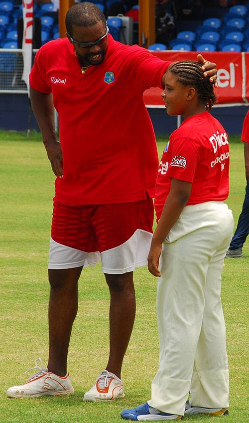 Kenny Benjamin encourages a participant at a coaching clinic