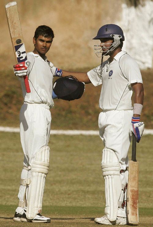 Subramaniath Badrinath is congratulated by Arjun Yadav on his hundred