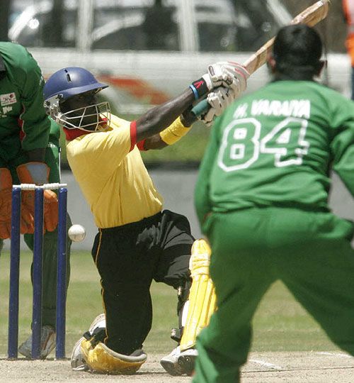 Joel Olwenyi misses a shot as the bowler Hiren Varaiya looks on