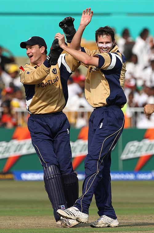 Craig Wright and Colin Smith celebrate the wicket of Shahid Afridi