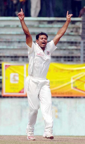 Mohammad Sharif, Dhaka's most successful bowler , on his way to 4 for 38