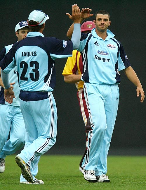 Mark Cameron is congratulated on a wicket