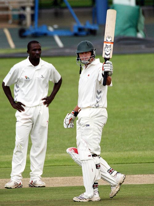 Shaun Liebisch raises his bat on reaching his fifty