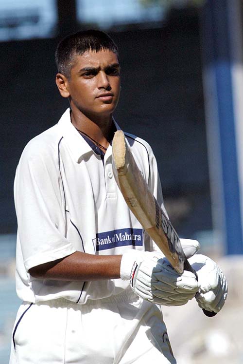 Harshad Khadiwale walks back after his innings of 126 for Maharashtra