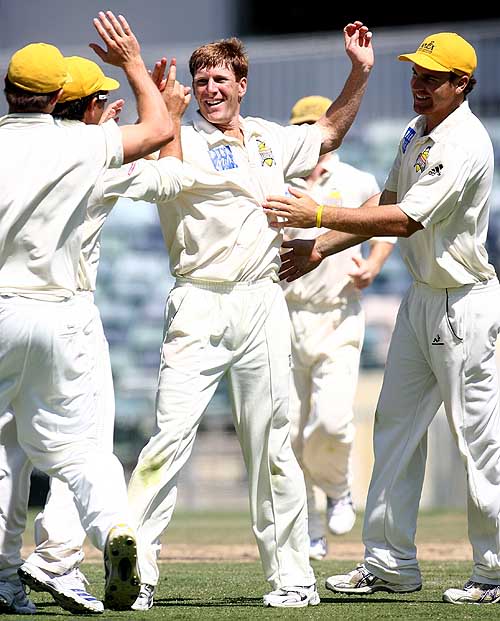 Mathew Inness is congratulated by his team-mates