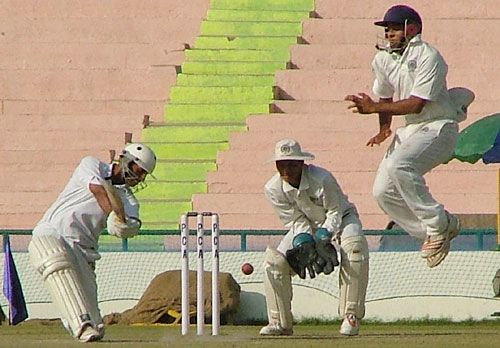 Silly point fielder Amol Sinde gets out of the way as Ravi Inder drives to the off side