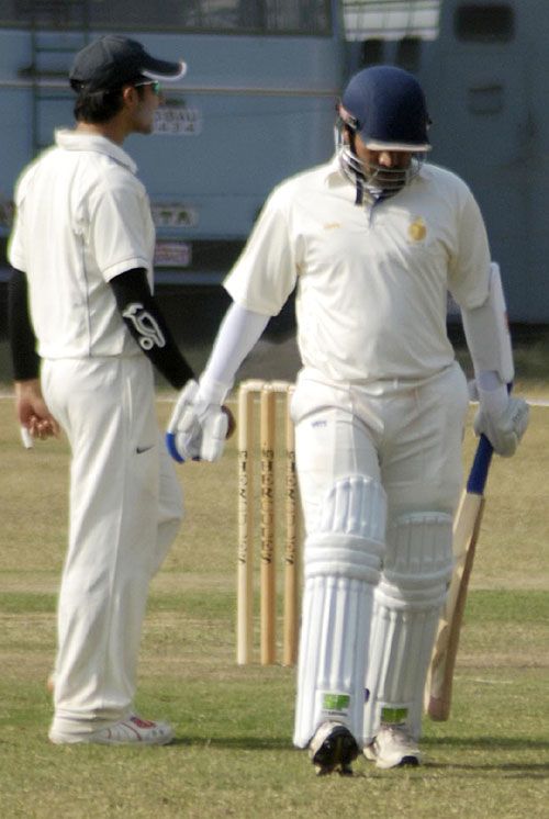 Madhya Pradesh captain Brijesh Tomar walks back after being dismissed 