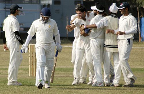 Jammu & Kashmir players celebrate the wicket of Brijesh Tomar 