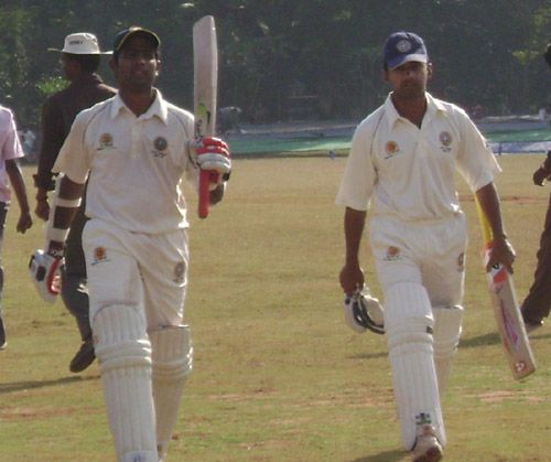 Sreekumar Nair and Vinan Nair walk off the field