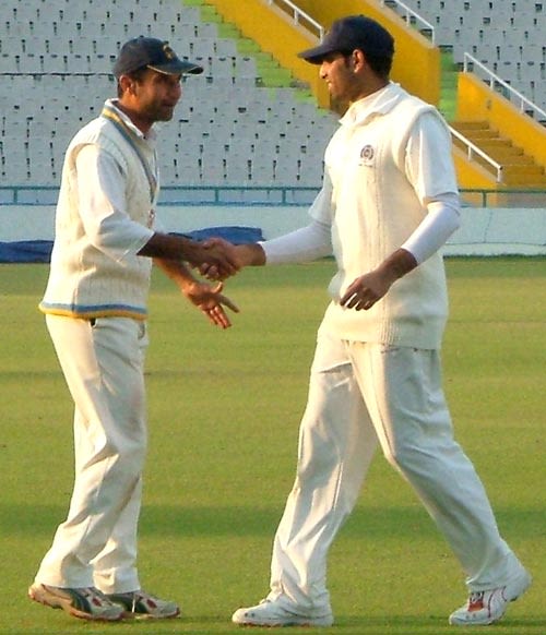 Pankaj Dharmani and VVS Laxman shake hands after the match