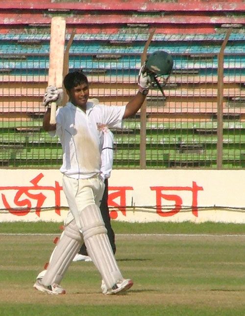 Gazi Salahuddin raises the bat after reaching his century against Sylhet