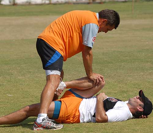 Nathan Astle does some stretches during training