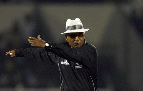 Suresh Shastri directs some spectators to move away from the sightscreen
