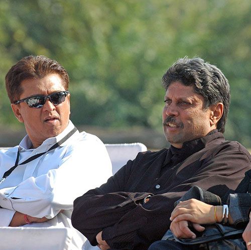 Kiran More and Kapil Dev watch the play-off for fifth place