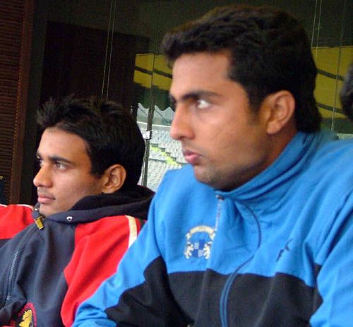 Punjab's Siddarth Kaul and VRV Singh watch the action from the sidelines