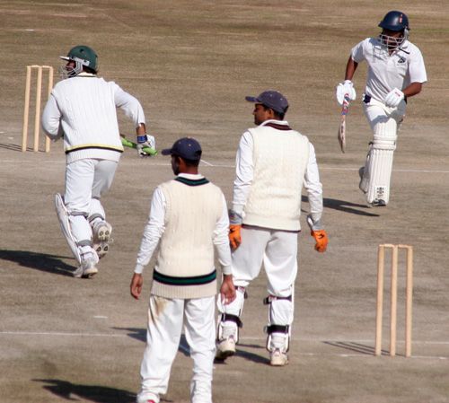 Mukesh Sharma and Hemant Dogra pick up a single during their 127-run stand for the second wicket