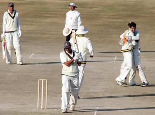 Rohit Jhalani walks back after being dismissed by Vishal Bhatia
