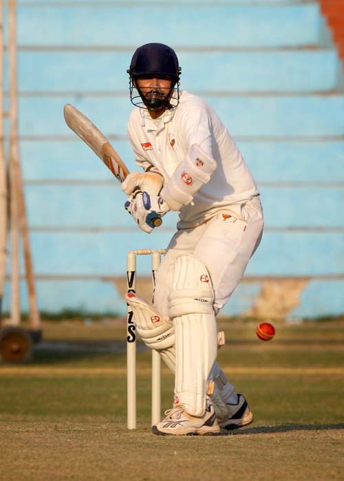 Nitesh Modi prepares to play a shot during his 49