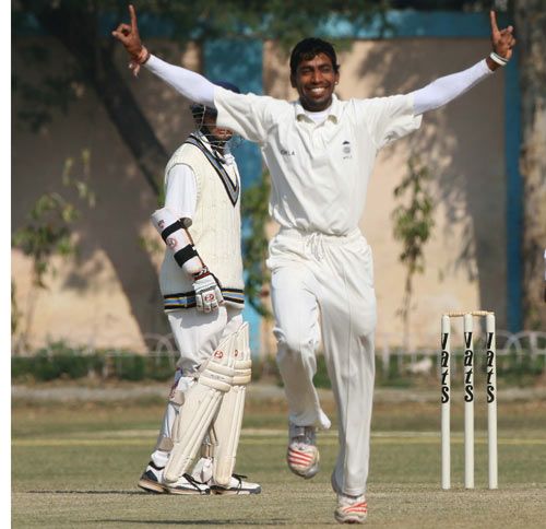 Madhya Pradesh's Sunil Dholpure is ecstatic after taking a wicket