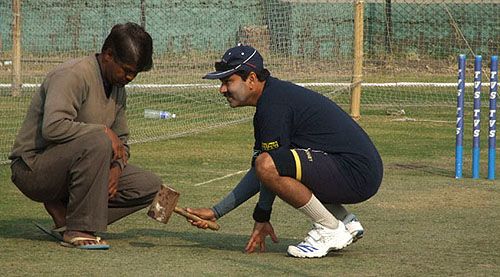 Delhi's bowling coach Manoj Prabhakar scrutinises the pitch