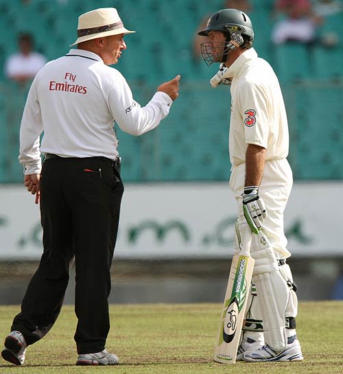 Ricky Ponting and the umpire Mark Benson exchange words