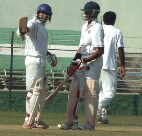 Rakesh Solanki raises the bat after his fifty