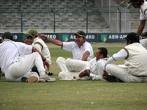 Hasan Raza and Younis Khan share a joke during a light-enforced break