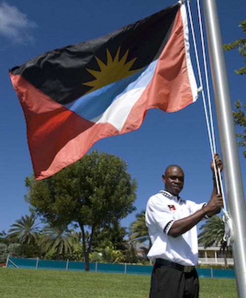 Sylvester Joseph hoists Antigua and Barbuda's flag