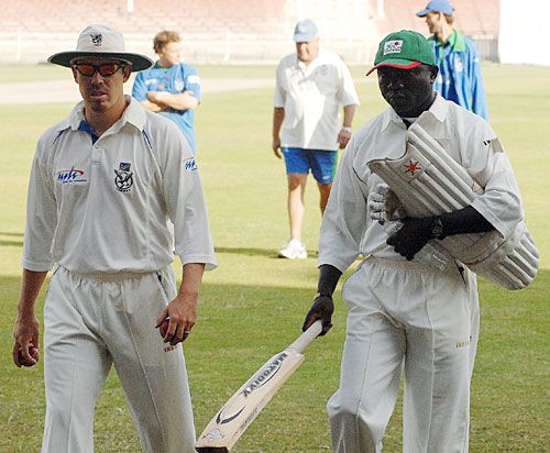 Steve Tikolo and Louis Burger return after the toss