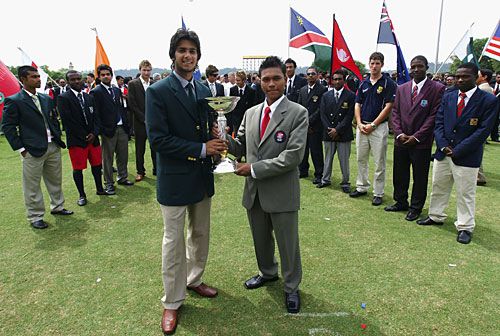 Imad Wasim and Ahmed Faiz pose with the ICC Under-19 World Cup trophy