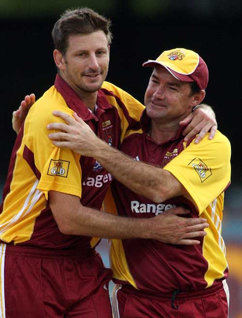 Jimmy Maher congratulates Michael Kasprowicz after his final delivery for Queensland