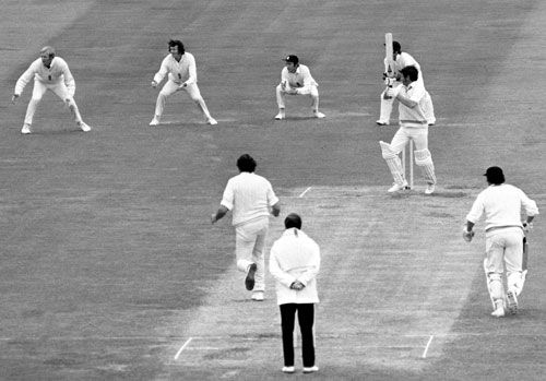 Bev Congdon cuts a ball from Geoff Arnold
