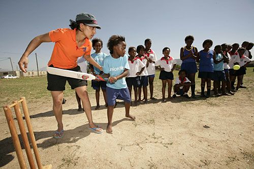 Violet Wattenberg gives batting tips to kids