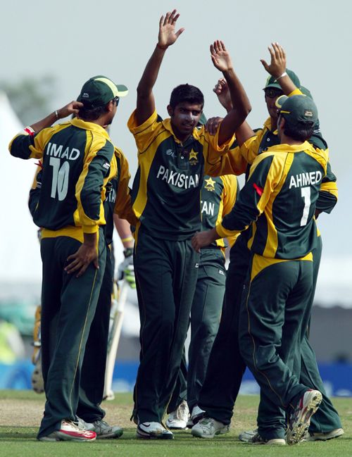 Adil Raza celebrates a wicket with his team-mates