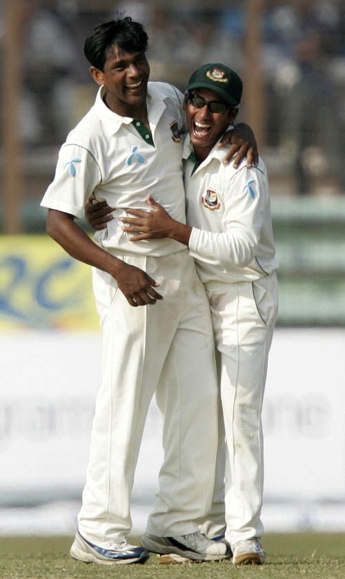Mohammad Rafique is congratulated by Mohammad Ashraful on his 100th Test wicket