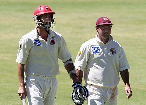 Jason Gillespie and Jimmy Maher leave the field for lunch during their last day of Pura Cup cricket