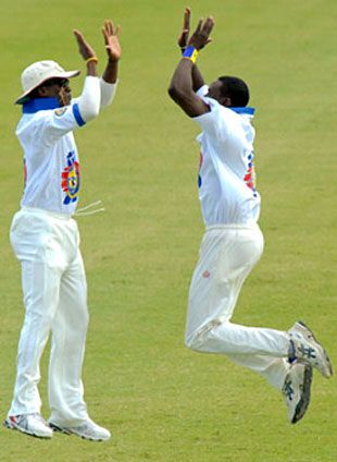 Pedro Collins celebrates another wicket with Kevin Stoute